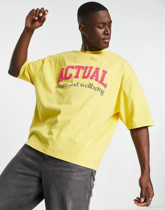 https://images.styletyx.com/images/asos-actual-oversized-t-shirt-with-boucle-health-wellbeing-logo-in-yellow-asos-design-1852465_3.webp