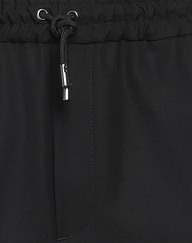 https://images.styletyx.com/images/black-cotton-twill-casual-pants-maison-kitsune-13378797_4.webp