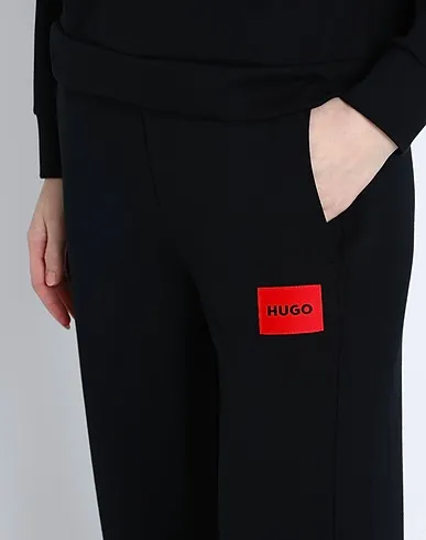 https://images.styletyx.com/images/black-jersey-casual-pants-hugo-boss-13155614_4.webp