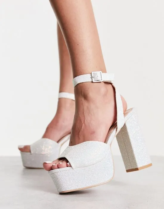 https://images.styletyx.com/images/bridal-alette-glitter-platform-sandals-in-white-and-silver-be-mine-12909871_3.webp