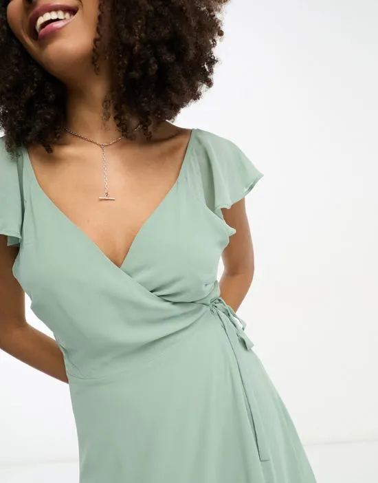 https://images.styletyx.com/images/bridesmaid-wrap-full-skirt-maxi-dress-with-flutter-sleeves-in-green-vila-119348463_4.webp