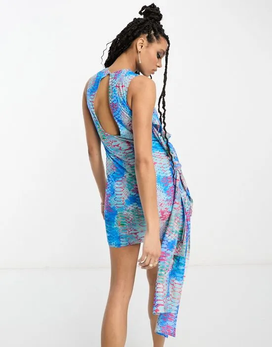 https://images.styletyx.com/images/bright-reptile-print-tie-detail-mini-dress-in-blue-multi-annorlunda-13233528_2.webp