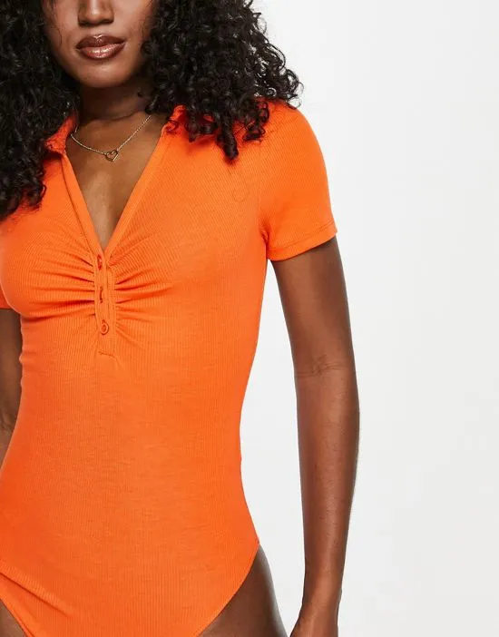 https://images.styletyx.com/images/button-through-ruched-bodysuit-in-orange-new-look-2808181_4.webp