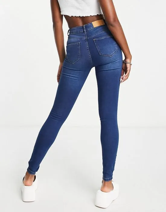 https://images.styletyx.com/images/callie-high-waist-skinny-jeans-in-mid-blue-wash-noisy-may-3108202_3.webp