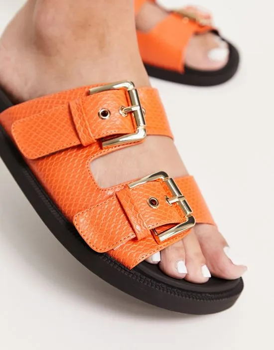 https://images.styletyx.com/images/chunky-double-buckle-footbed-slides-in-orange-london-rebel-wide-fit-13315879_3.webp