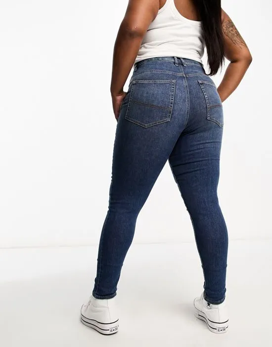 https://images.styletyx.com/images/collusion-plus-x001-high-waisted-skinny-jeans-in-mid-blue-collusion-2765920_5.webp