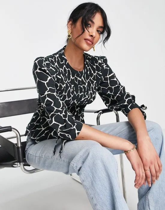 https://images.styletyx.com/images/cotton-smocked-blouse-in-animal-print-black-whistles-1886826_1.webp