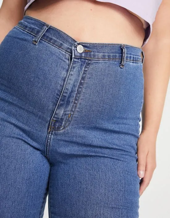 https://images.styletyx.com/images/dtt-plus-chloe-high-waist-disco-stretch-skinny-jeans-in-mid-wash-blue-don-t-think-twice-plus-2771879_3.webp