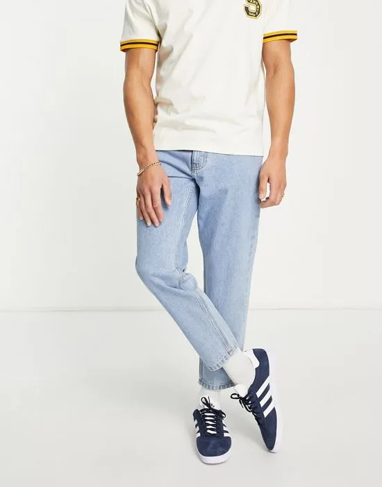https://images.styletyx.com/images/dtt-rigid-tapered-fit-jeans-in-light-stone-wash-blue-don-t-think-twice-2616975_1.webp