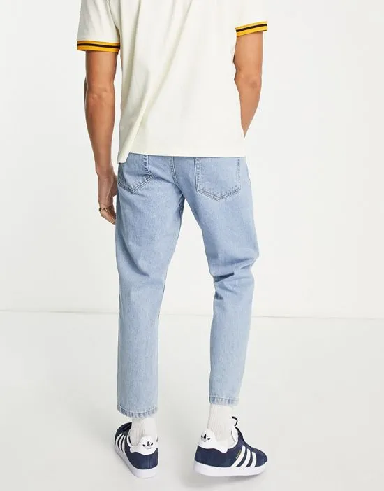 https://images.styletyx.com/images/dtt-rigid-tapered-fit-jeans-in-light-stone-wash-blue-don-t-think-twice-2616975_2.webp