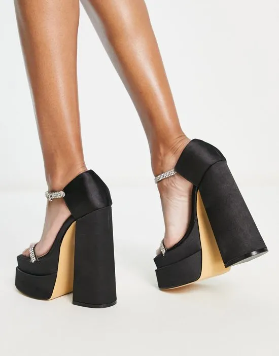 https://images.styletyx.com/images/ego-peggy-platform-heel-sandals-with-embellished-straps-in-black-ego-3037636_2.webp