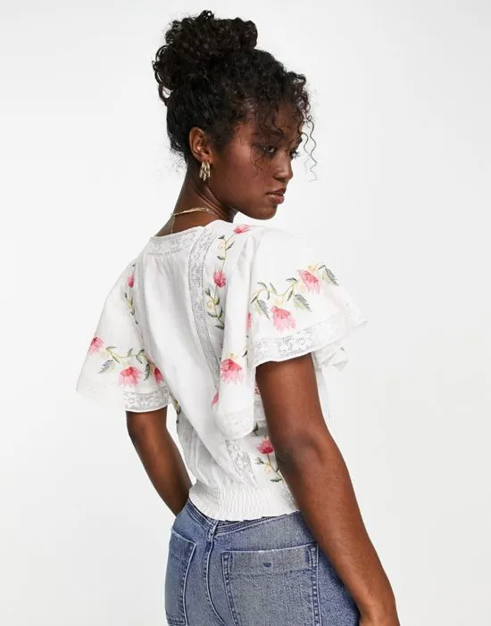 https://images.styletyx.com/images/embroidered-frill-crop-top-in-white-lipsy-1883219_2.webp