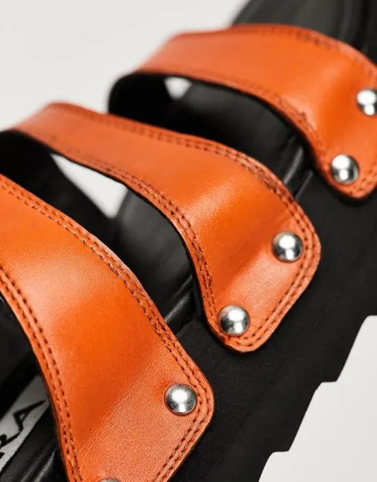 https://images.styletyx.com/images/exclusive-sabian-3-strap-chunky-slide-sandals-in-orange-leather-asra-873976239_3.webp