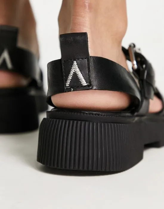 https://images.styletyx.com/images/exclusive-samba-flat-sandals-with-buckle-strap-in-black-leather-asra-871690144_2.webp