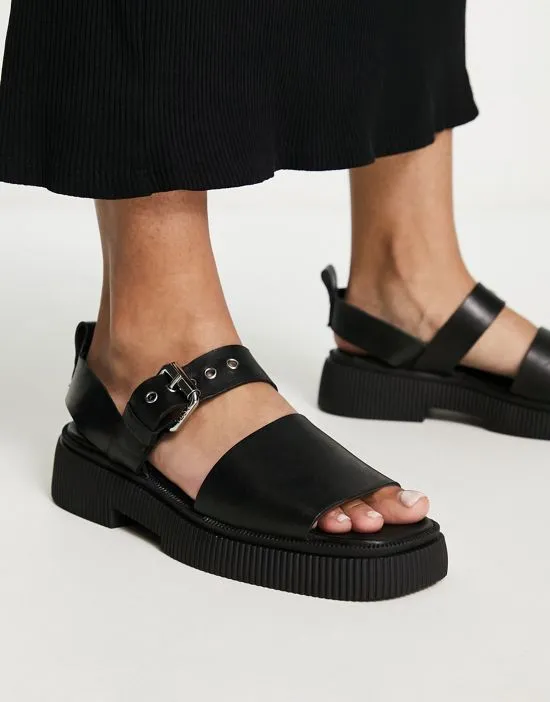 https://images.styletyx.com/images/exclusive-samba-flat-sandals-with-buckle-strap-in-black-leather-asra-871690144_3.webp