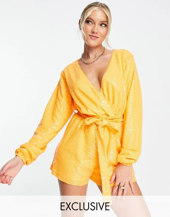 https://images.styletyx.com/images/exclusive-sequin-wrap-detail-belted-romper-in-orange-in-the-style-2707433_1.webp