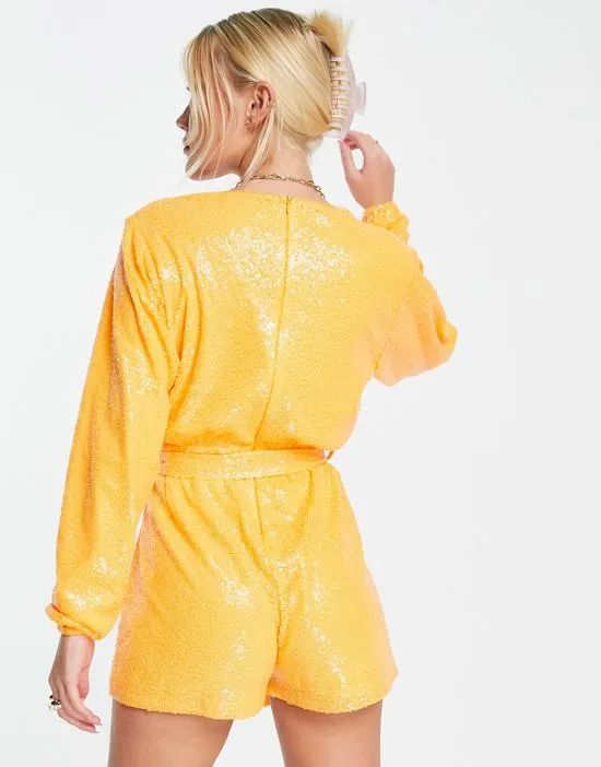 https://images.styletyx.com/images/exclusive-sequin-wrap-detail-belted-romper-in-orange-in-the-style-2707433_3.webp