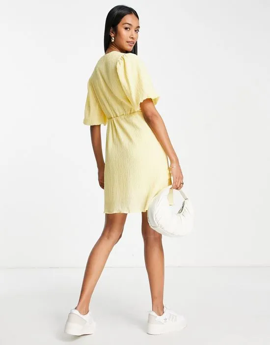 https://images.styletyx.com/images/exclusive-textured-mini-dress-with-ruffle-seam-detail-in-pastel-yellow-vila-1823178_2.webp