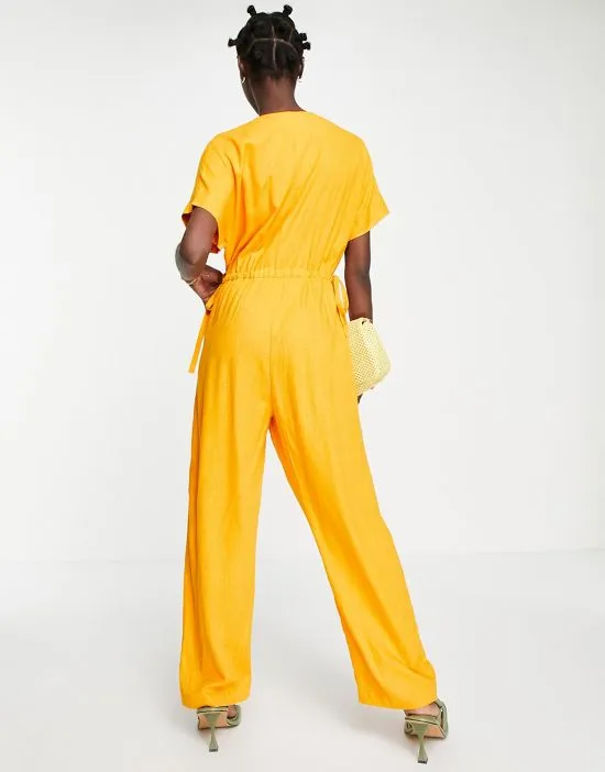 https://images.styletyx.com/images/femme-linen-blend-jumpsuit-with-tie-waist-in-orange-selected-1753857_2.webp