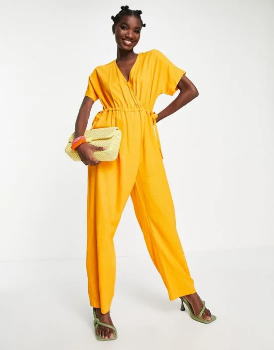 https://images.styletyx.com/images/femme-linen-blend-jumpsuit-with-tie-waist-in-orange-selected-1753857_4.webp