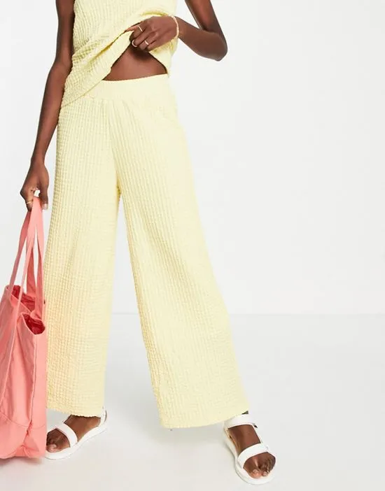 https://images.styletyx.com/images/femme-textured-wide-leg-pants-in-pastel-yellow-part-of-a-set-yellow-selected-3140168_1.webp