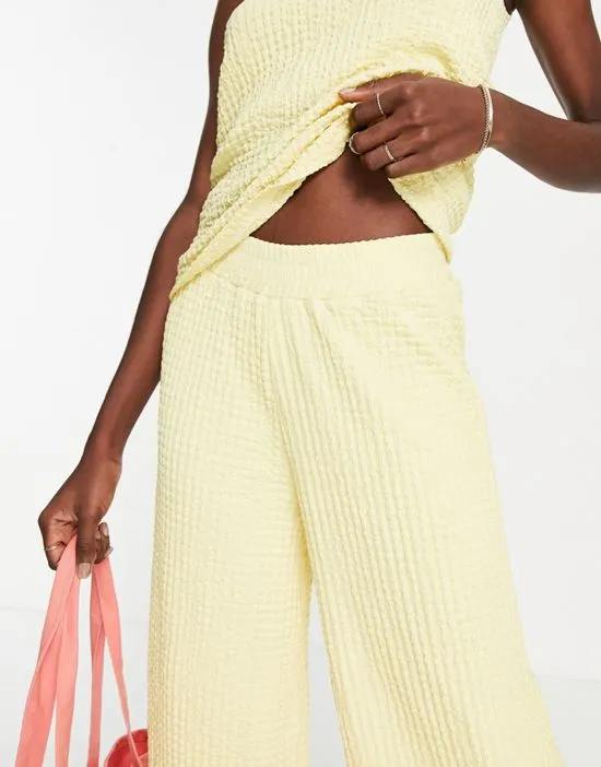 https://images.styletyx.com/images/femme-textured-wide-leg-pants-in-pastel-yellow-part-of-a-set-yellow-selected-3140168_3.webp