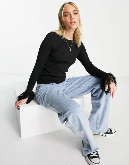 https://images.styletyx.com/images/fitted-ribbed-sweater-with-fluffy-cuffs-in-black-wednesday-s-girl-2755694_3.webp