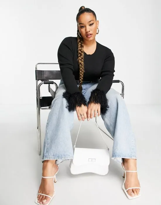 https://images.styletyx.com/images/fitted-ribbed-sweater-with-fluffy-cuffs-in-black-wednesday-s-girl-curve-2568900_2.webp