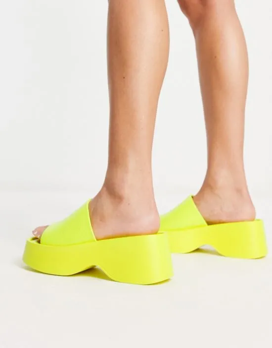 https://images.styletyx.com/images/flatform-square-toe-slide-in-yellow-london-rebel-wide-fit-13315871_3.webp