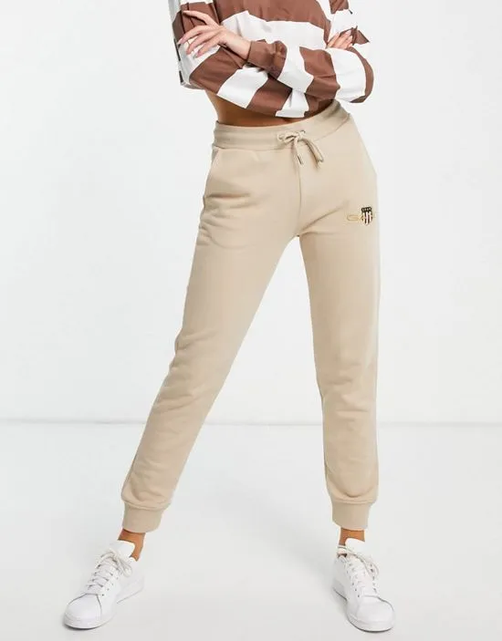 https://images.styletyx.com/images/gant-archive-shield-sweat-pant-in-sand-gant-2265107_1.webp
