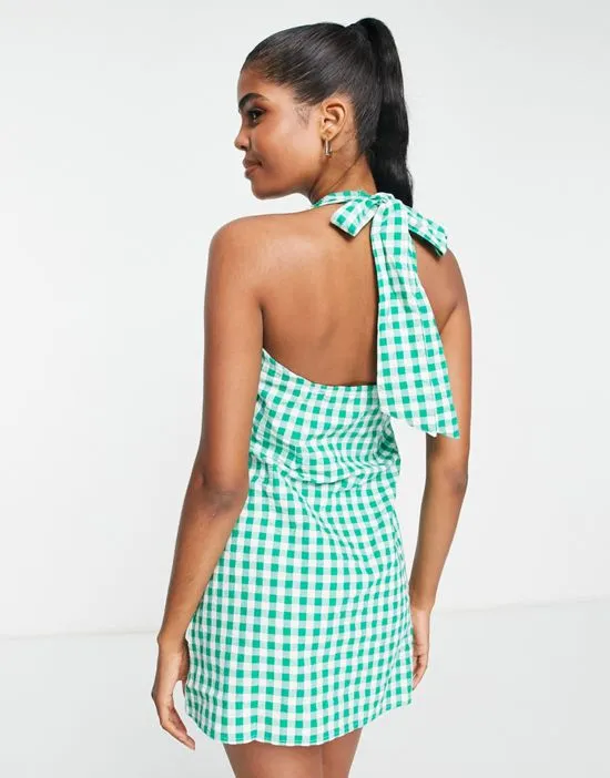 https://images.styletyx.com/images/halter-neck-mini-dress-in-green-gingham-print-influence-3139080_2.webp