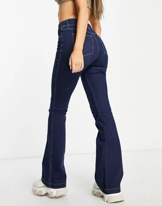 https://images.styletyx.com/images/high-rise-flare-jeans-in-dark-wash-spanx-1905704835_2.webp
