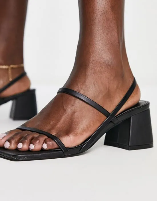 https://images.styletyx.com/images/just-realise-strappy-mid-heel-sandals-in-black-pu-public-desire-1738569_2.webp