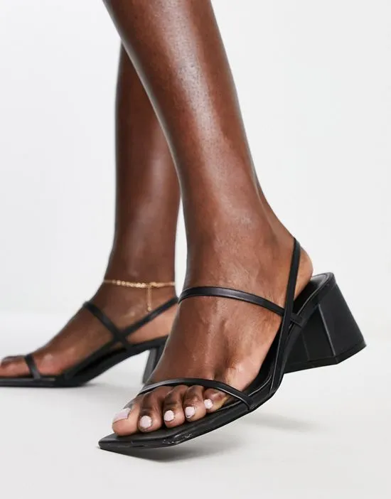 https://images.styletyx.com/images/just-realise-strappy-mid-heel-sandals-in-black-pu-public-desire-1738569_3.webp