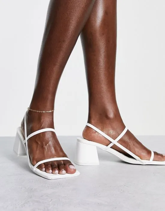 https://images.styletyx.com/images/just-realise-strappy-mid-heel-sandals-in-white-pu-public-desire-2801952_2.webp
