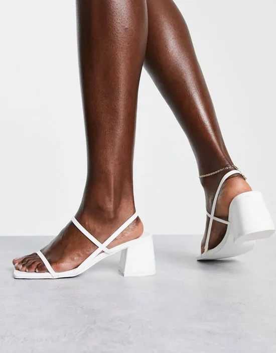 https://images.styletyx.com/images/just-realise-strappy-mid-heel-sandals-in-white-pu-public-desire-2801952_3.webp