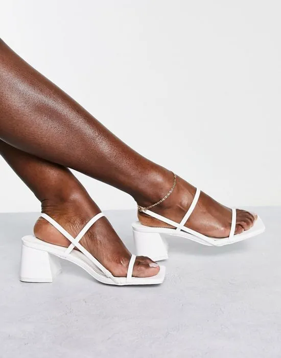 https://images.styletyx.com/images/just-realise-strappy-mid-heel-sandals-in-white-pu-public-desire-2801952_4.webp