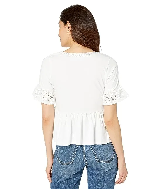https://images.styletyx.com/images/knit-eyelet-flutter-sleeve-top-draper-james-3173170_2.webp