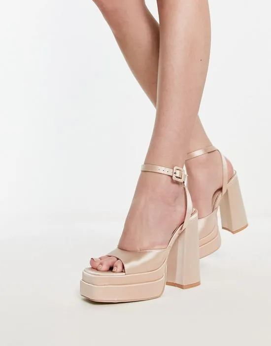 https://images.styletyx.com/images/krista-platform-sandals-in-champagne-satin-be-mine-13313826_1.webp