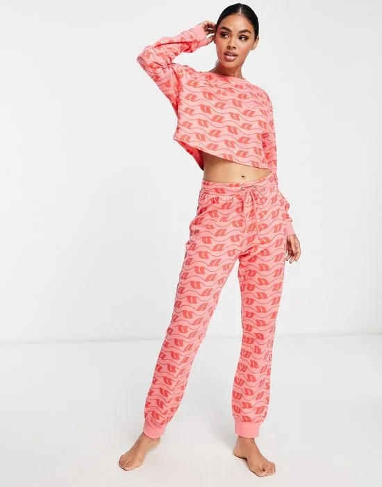 https://images.styletyx.com/images/lounge-monogram-print-sweatshirt-sweatpants-set-in-pink-red-asos-design-2568822_1.webp