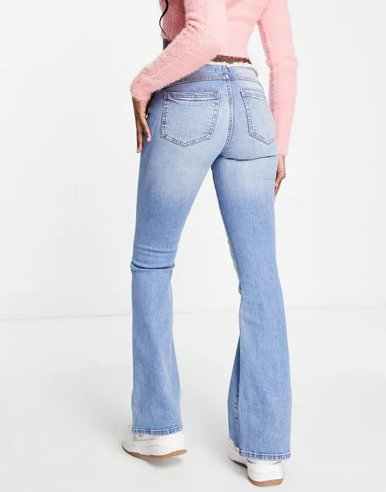 https://images.styletyx.com/images/low-rise-raw-waistband-flare-jean-in-mid-wash-blue-miss-selfridge-13211490_2.webp