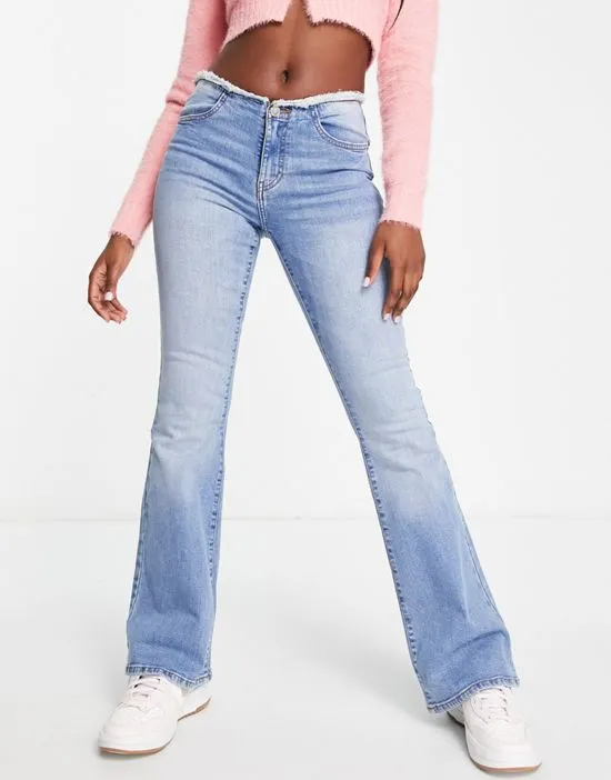 https://images.styletyx.com/images/low-rise-raw-waistband-flare-jean-in-mid-wash-blue-miss-selfridge-13211490_4.webp