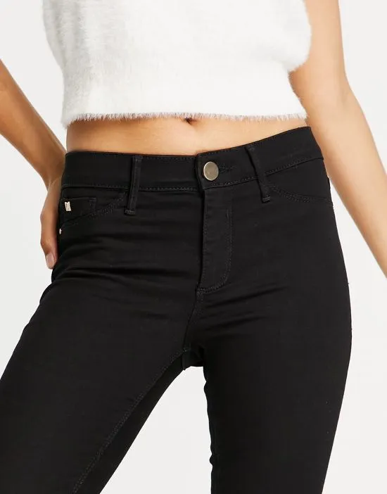 https://images.styletyx.com/images/mid-rise-skinny-jeans-in-black-river-island-1784504_3.webp