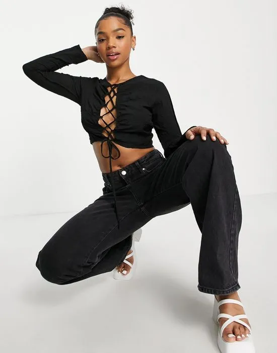 https://images.styletyx.com/images/open-cross-strap-crop-top-in-black-lola-may-1945853_3.webp