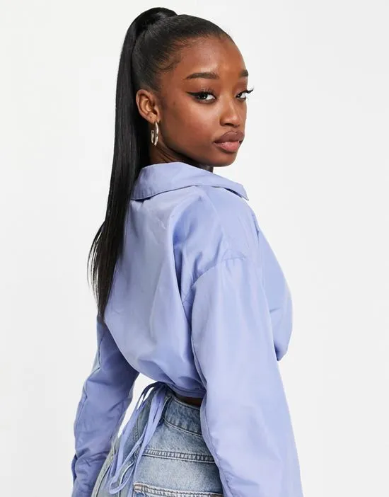 https://images.styletyx.com/images/poplin-wrap-around-waist-shirt-in-blue-missguided-1885412_2.webp