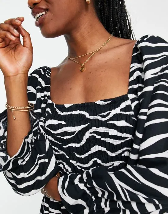 https://images.styletyx.com/images/puff-sleeve-zebra-print-midi-dress-in-black-new-look-3237875_3.webp