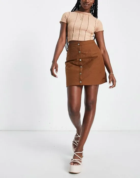 https://images.styletyx.com/images/quilted-button-through-mini-skirt-in-brown-lola-may-2766948_4.webp