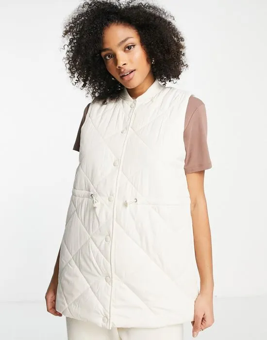 https://images.styletyx.com/images/quilted-vest-in-cream-pieces-2489287_3.webp