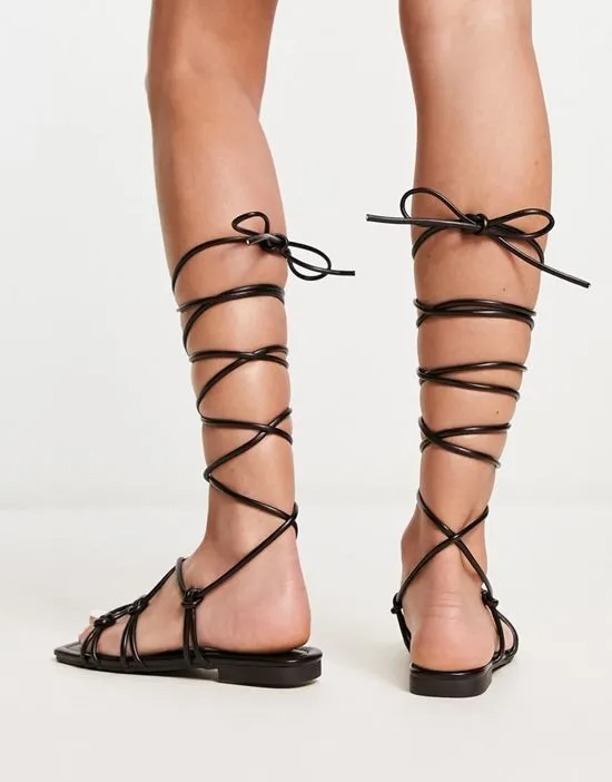 https://images.styletyx.com/images/raid-exclusive-strappy-ghillie-tie-sandals-in-black-raid-13274545_2.webp