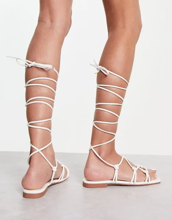 https://images.styletyx.com/images/raid-exclusive-strappy-ghillie-tie-sandals-in-off-white-raid-13274546_2.webp